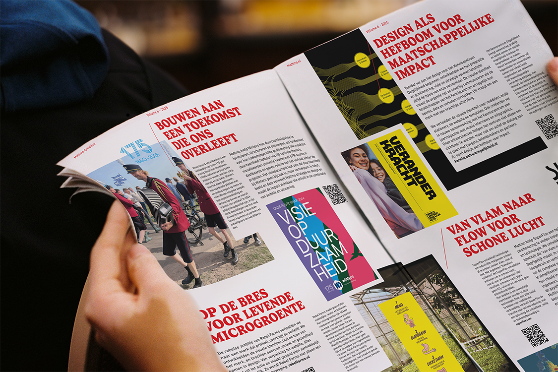 Hands holding open a printed Mattmo magazine spread with bold red headlines and colourful inset graphics.