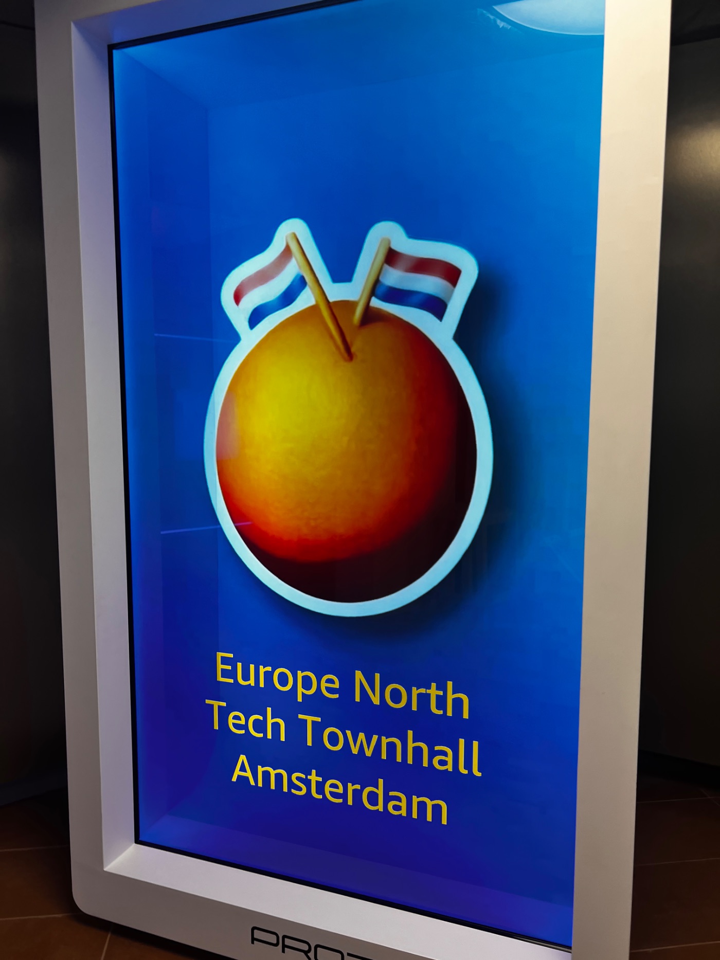 Europe North Tech Townhall Amsterdam welcome screen with a Dutch-flagged orange.