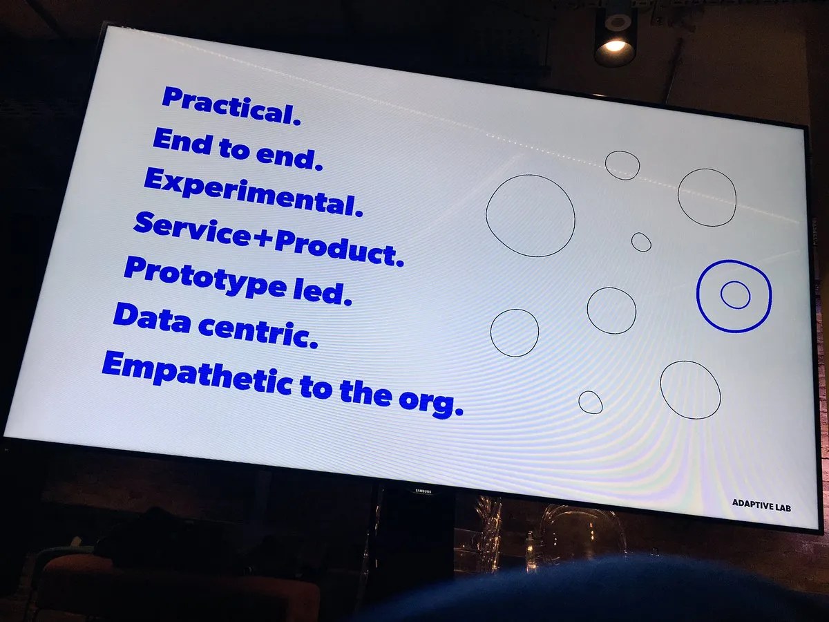 Adaptive Lab slide listing their approach: practical, end to end, experimental, service and product, prototype led, data centric, empathetic to the org.