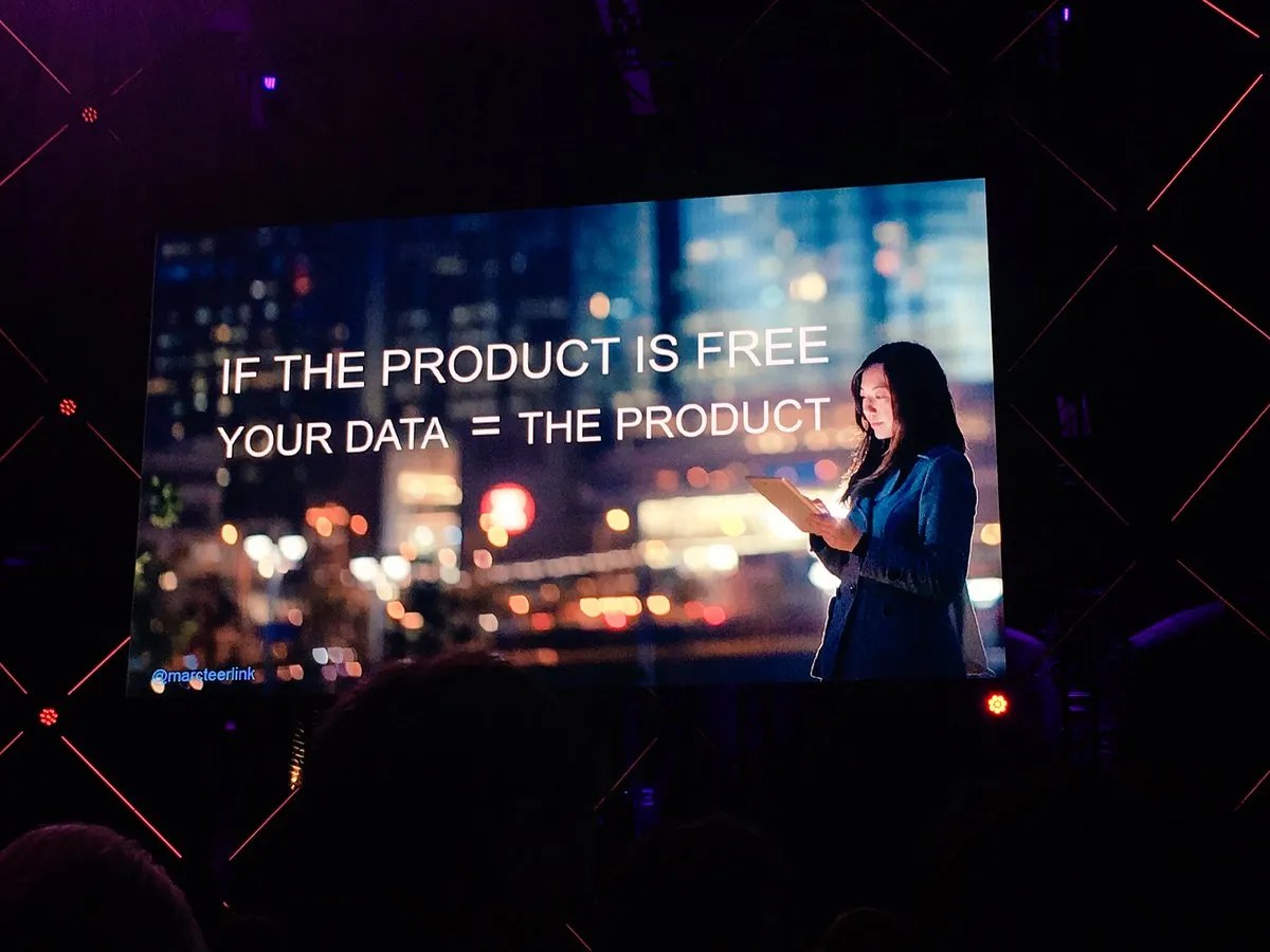 Slide reading &lsquo;If the product is free, your data = the product&rsquo; over a night-time cityscape.