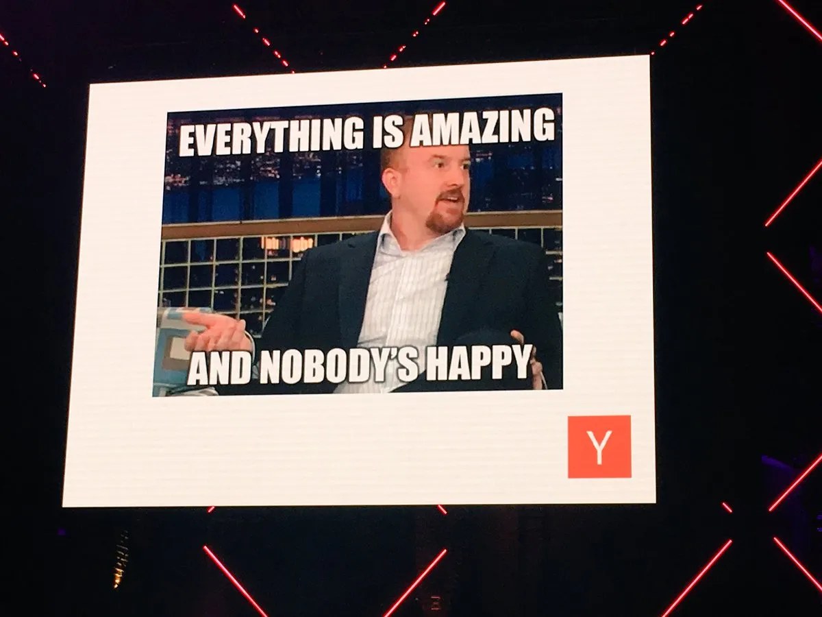 Meme slide reading &lsquo;Everything is amazing and nobody&rsquo;s happy&rsquo;, over a still of Louis C.K. on a late-night show.